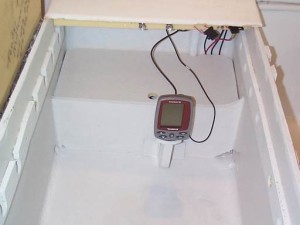 Depth sounder stored on side of battery locker with battery cover installed